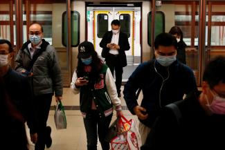 People wear protective masks following the outbreak of a new coronavirus, during their morning commute in a station, in Hong Kong, China February 10, 2020.