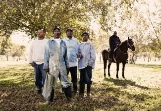 Jimmy Jackson, age 63, at the front of the group in the Pecan Field at Angola. 