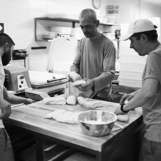 Bakers knead dough during the Battle of Kyiv at Bakehouse in Kyiv, Ukraine, March 13, 2022