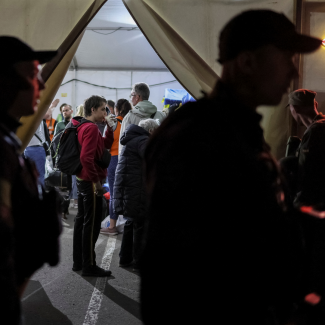 Refugees from the Azovstal steel plant in Mariupol stand in lines at a registration and humanitarian aid center for internally displaced people amid Russia's ongoing war in Ukraine, in Zaporizhzhia, Ukraine, on May 8, 2022. 