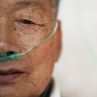 A close-up photo of the face of Hu Hushen, a 78-year-old former miner, breathes with the help of extra oxygen. Pictured at Yangjia Hospital in Zhejiang Province, China, on October 19, 2015. 