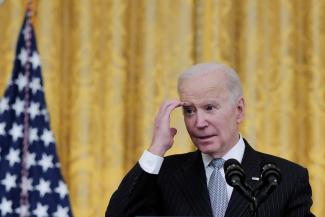 U.S. President Joe Biden gestures at an event to reignite the 'Cancer Moonshot' initiative with a goal to reduce cancer death by 50 percent over the next 25 years, in the East Room at the White House in Washington, D.C., U.S., February 2, 2022.