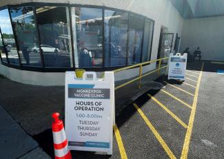 A sign for a monkey pox clinic is seen in a parking lot