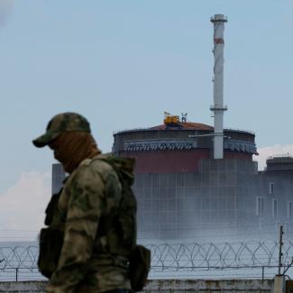 A Russian soldier stands guard near the Zaporizhzhia nuclear power plant outside the Russian-controlled city of Enerhodar on August 4, 2022.