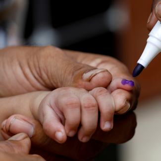 A close-up image of a child's hand being marked with a purple pen after he is administered polio vaccine drops, during an anti-polio campaign in Karachi, Pakistan, on July 20, 2020. 