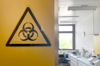 A large yellow biohazard sign on the wall at the bio-containment facility at Spiez Laboratory, available to WHO as a repository for COVID viruses and other pathogens with pandemic potential, in Spiez, Switzerland, June 8, 2022. 