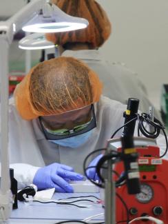 A worker assembles parts of a COVID-19 test kit made by Visby Medical at the kit maker's lab in San Jose, California, U.S., August 28, 2020.