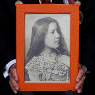 A close-up of the hands of Charles Norman Shay, a member of the Penobscot Nation and a World War II veteran, holding a picture of his mother Florence. Photo taken in Bretteville l'Orgueilleuse, France, on May 18, 2019. 