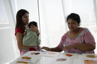 Adriana Zavalaga, left, hosts a nutrition workshop for families who have children with cleft palate and cleft lip, in Peru, in March 2021.