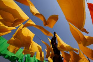 A worker dries fabrics at a dye factory in Narayanganj, Bangladesh, on March 9, 2022.