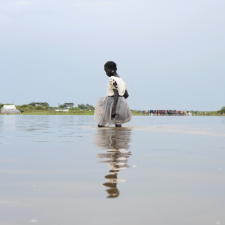 A girl dressed in white walks knee-deep in water after heavy rains and floods in the town of Pibor, Boma state, South Sudan, on November 6, 2019.