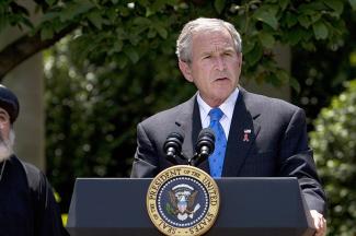 President George W. Bush speaks on the President's Emergency Plan for AIDS Relief as Bishop Paul Yowakim looks on, in the Rose Garden of the White House in Washington, DC, on May 30, 2007. 