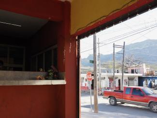 A snapshot of town from the inside of a taco shop, Hidalgo, Nuevo León, Mexico. January 2023.