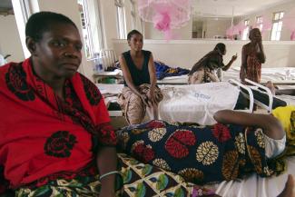 Rukia Kondogoza, a cervical cancer patient, shares a bed in a female ward of a cancer institute in the capital Dar es Salaam, Tanzania, on November 11, 2009. 