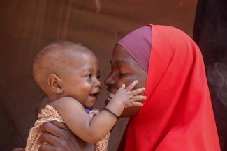 Nadifa Abdi Isak plays with her son Farhan, who recently received an emergency transfusion to treat malnutrition-induced anaemia in Mogadishu, Somalia December 1, 2022.