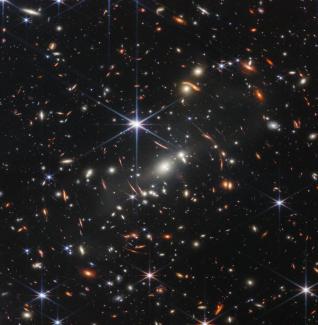 Thousands of galaxies flood this near-infrared image of galaxy cluster SMACS 0723. High-resolution imaging from NASA’s James Webb Space Telescope combined with a natural effect known as gravitational lensing made this finely detailed image possible. 