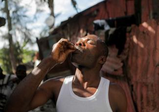 A man takes an oral cholera vaccine handed out by health workers of Haiti's Ministry of Public Health and Population (MSPP) after cholera reemerged in the Caribbean island nation in early October, in Port-au-Prince, Haiti December 19, 2022.