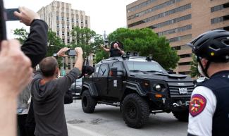 Alex Jones, the Infowars host and conspiracy theorist, greets protesters demonstrating against extended stay-at-home order to help slow the spread of COVID-19, in Austin, Texas, on April 18, 2020.