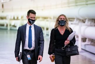 Rep. Marjorie Taylor Greene (R-GA) wears a protective mask reading "This mask is as useless as Joe Biden" as she walks with an aide to a vote on Capitol Hill, in Washington, DC, on February 25, 2021.