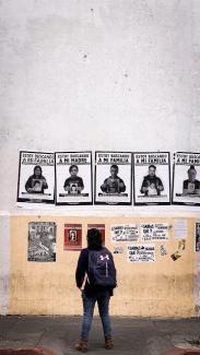  A man stands in Guatemala City to view posters of children illegally placed for adoption and searching for their families.