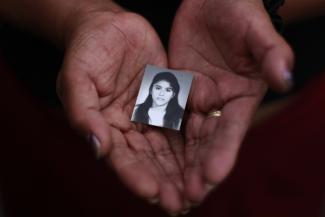 A family member holds a photograph of Rosivel Elisabeth Grande in Quezaltepeque, Honduras, on July 2, 2013. Grande was killed by an unidentified man who shot her five times when she was going to work 