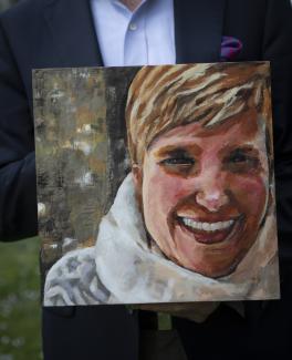  Corey Feist, cofounder of the Doctor Lorna Breen Heroes Foundation, holds a painting of his late sister-in-law at his home in Charlottesville, Virginia, on April 7, 2021.