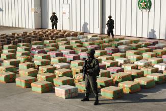Colombian antidrugs policemen guard stacks of marijuana seized from the rural area of El Jagual at a military police base in Popayan, Colombia, on October 23, 2011.