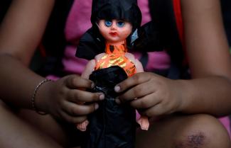 A child attends a protest against the rape of an eight-year-old girl in Kathua, near Jammu,  and a teenager in Unnao, Uttar Pradesh state, in New Delhi, India, on April 15, 2018.