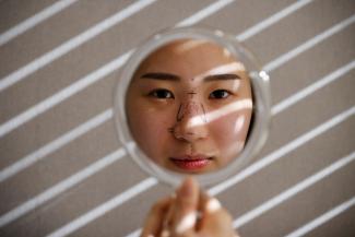 Ryu Han-na poses for photographs before undergoing nose plastic surgery at WooAhIn Plastic Surgery Clinic in Seoul, South Korea, on December 17, 2020.