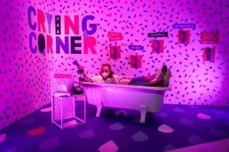 A woman poses inside a bathtub, simulating that she is calling her psychologist, in a crying space, 'La Lloreria,' to raise awareness about mental health, in Madrid, Spain, on October 17, 2021. 