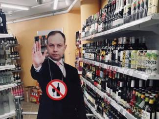 A life-size cutout of Professor Aurelijus Veryga is used to block the path to buying alcohol in a supermarket during hours when alcohol sales are prohibited in Lithuania, January 7, 2019.