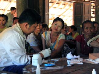 A government health worker takes a blood sample from a woman to be tested for malaria in Ta Gay Laung village hall in Hpa-An district in Kayin State, southeastern Myanmar, November 28, 2014. 