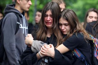 People react as they pay tribute following a school mass shooting after a boy opened fire on others, killing fellow students and staff in Belgrade, Serbia, May 4, 2023. 
