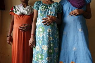 Surrogate mothers Daksha (thirty-seven), Renuka (twenty-three), and Rajia (thirty-nine) pose inside a temporary home for surrogates provided by Akanksha IVF centre in Anand town near Ahmedabad, India.