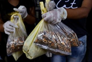 College students show their collected cigarette filter tips to be used for recycling during a collection drive in New Delhi, India, September 14, 2022.