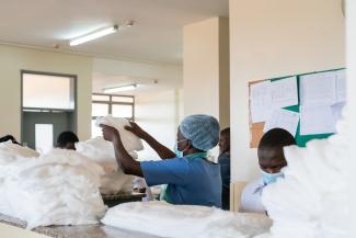 Nurses at Kiruddu National Referral Hospital in Kampala Uganda preparing the gauze and dressing to change patient bandages on the burn ward. 