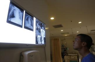 A doctor looks at X-ray films at Vinmec hospital in Hanoi, Vietnam, on September 12, 2014.