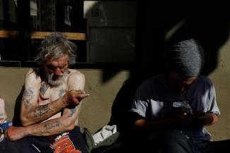 Travis Hayes, 65, injects what he says is the synthetic drug fentanyl, across the street from where San Francisco mayor London Breed just held a news conference introducing legislation in curbing the rise of deadly overdoses in the city, at the Tenderloin section of San Francisco, California, U.S., February 27, 2020. 