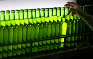 A man picks a green bottle at an assembly line inside the Taiwan Beer factory in Jhunan, Miaoli County, Taiwan, February 13, 2008.