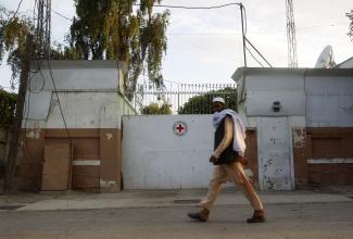 A man walks past the front gate of the International Committee of the Red Cross (ICRC) office in Jalalabad province