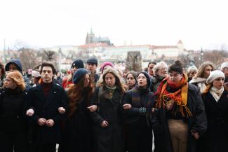 Students create a human chain in memory of victims of the shooting at Prague University.