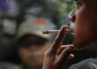 A man smokes a cigarette.