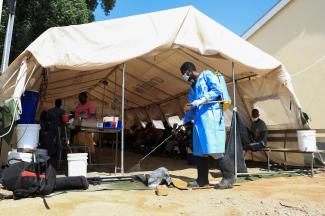 A health worker disinfects a cholera tent at Kuwadzana Polyclinic in Harare