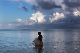 Kaibakia Pinata prepares to cast his net as he wades through water just off Bikeman Islet.