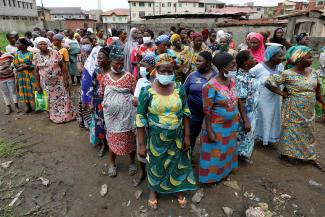 Women queue for food parcels during distribution by volunteers of the Lagos food bank initiative.