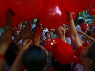 People take balloons before a march ahead of World AIDS Day 2013 at Kandawgyi garden in Yangon November 30, 2013. About one thousand people, including HIV/Aids patients, attended the event.