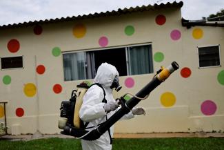 A health worker sprays insecticide to kill the Aedes aegypti mosquitos to help mitigate a dengue outbreak at a public school in Brasilia, Brazil, February 16, 2024.