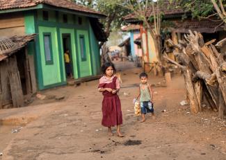 Children walk near a general store.