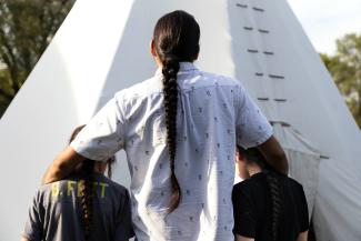 Austin Owen stands with his sons who try to keep Dakota tradition alive after Art Owen's passing due to a diabetes-related heart attack.