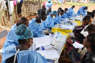 Congolese health workers register people before they are vaccinated against ebola.